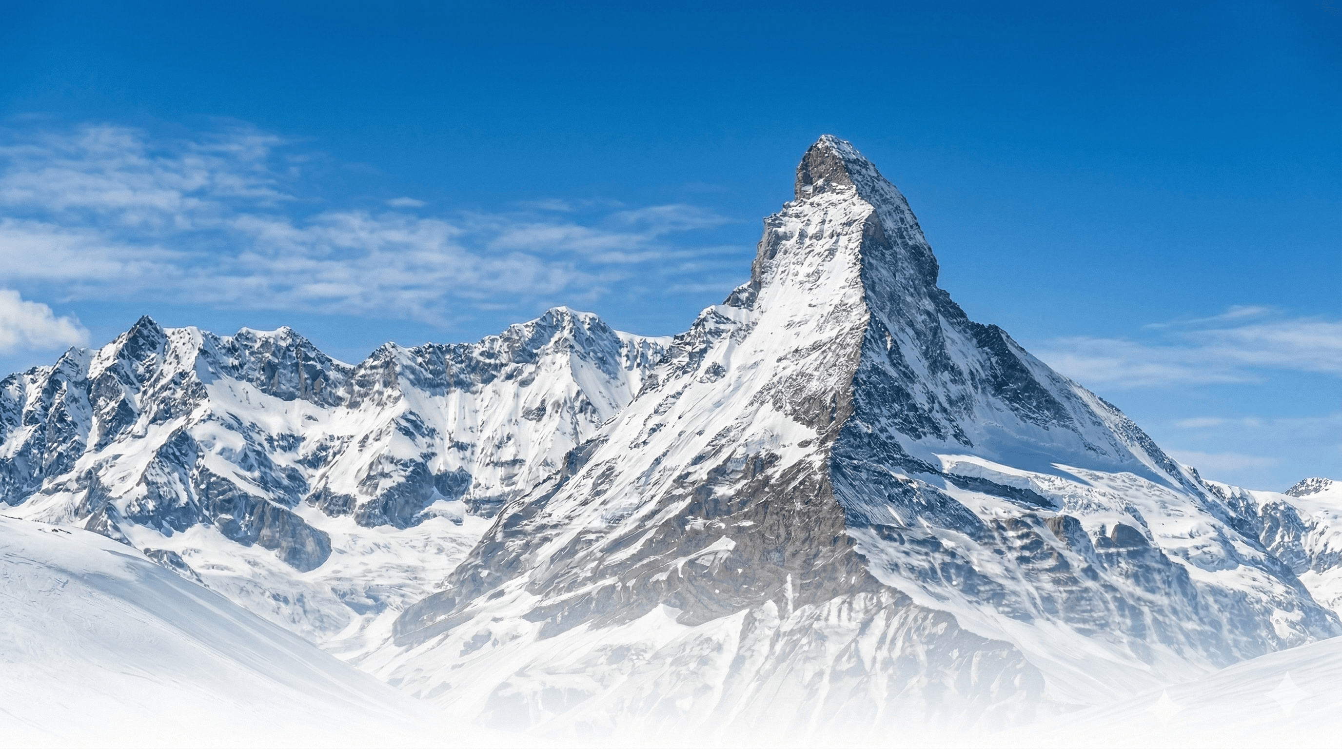 Snow-covered Matterhorn peak and Swiss Alps ridgeline under a clear blue sky